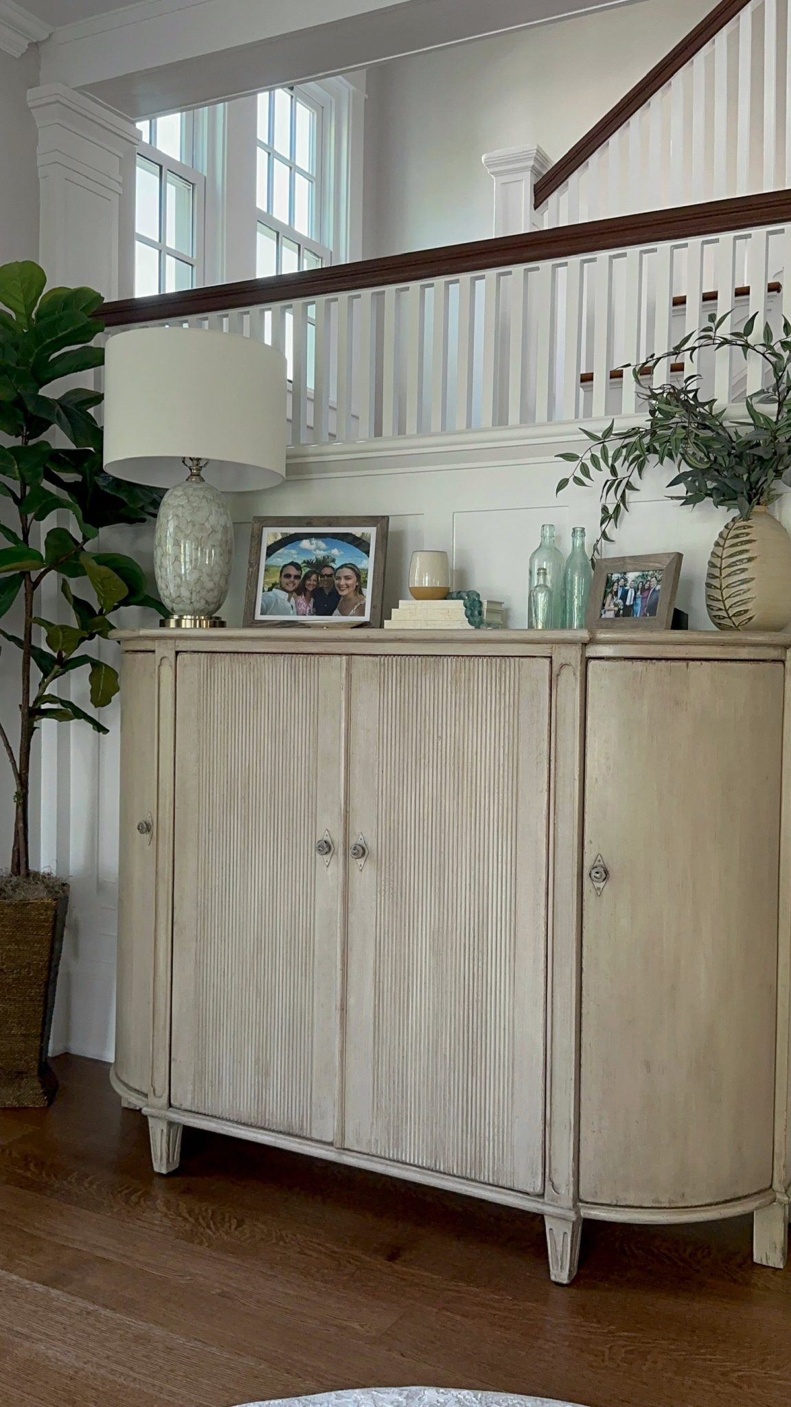 A white sideboard in a living room adds a touch of interior design elegance to the space.