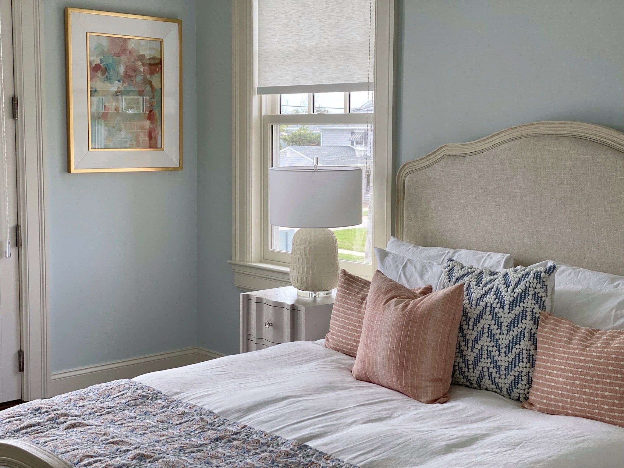An interior design featuring a bed in a bedroom with blue walls.