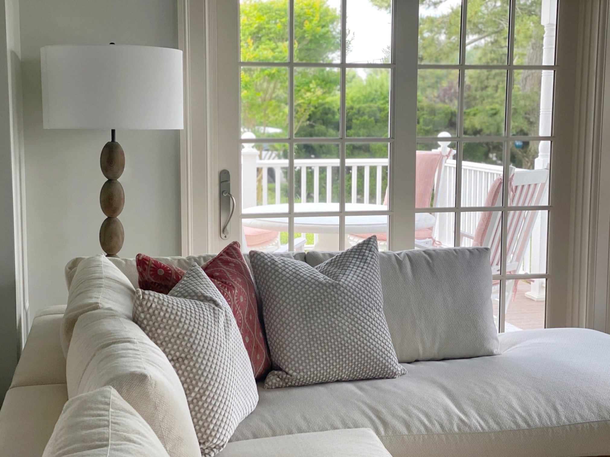 An interior design featuring a white couch and pillows in the living room.