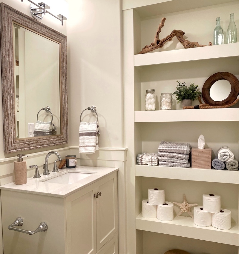 A white bathroom with shelves and a sink designed for interior design.
